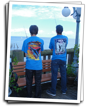 two guys wearing Guy Harvey graphic shirts while fishing